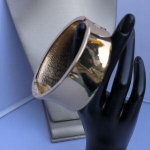 Statement gold-tone hinged cuff bracelet, wide, geometric concave design